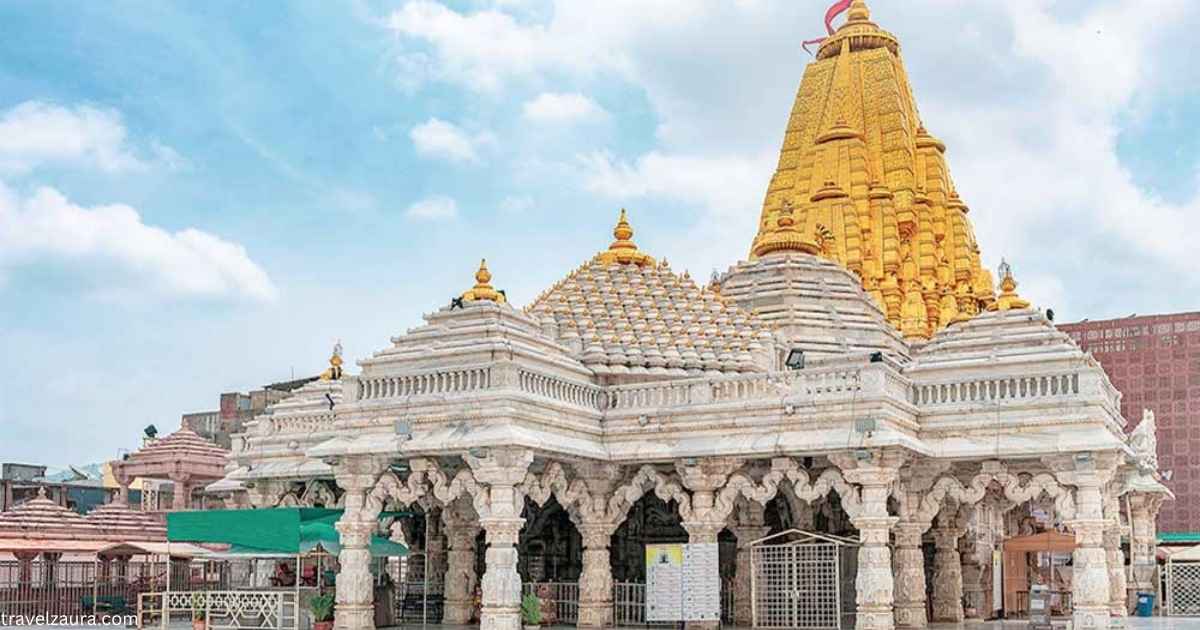 Ambaji Mandir temple entrance with devotees during darshan.