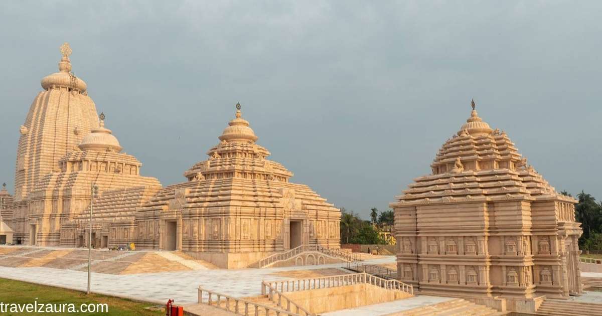 Digha Jagannath Temple lit up at sunset by the sea.