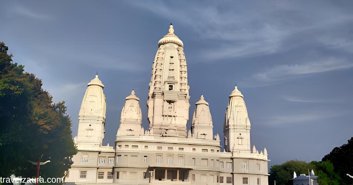 JK Temple Kanpur white marble facade with landscaped garden at sunset.
