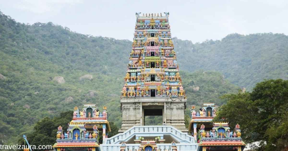 Marudhamalai Murugan Temple gopuram overlooking Coimbatore at sunrise.