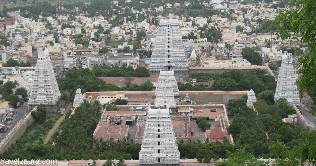 Devotees at Arunachaleswarar Temple gopuram, Thiruvannamalai temple timings at sunrise.